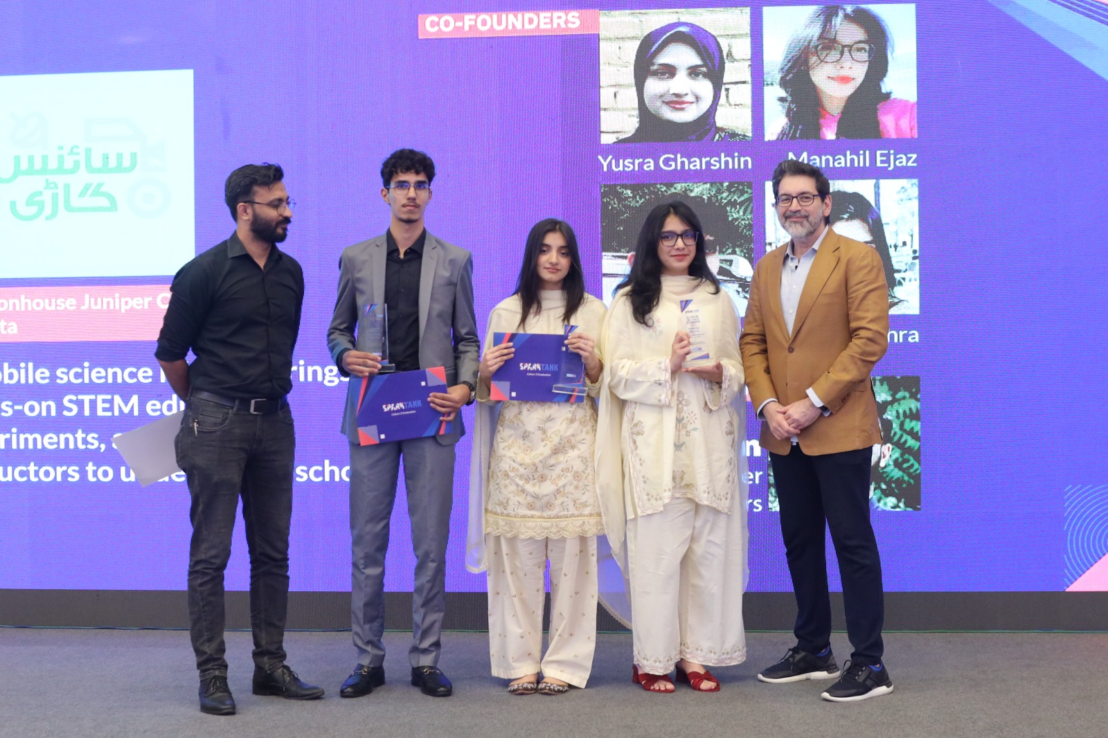 Students receiving certificates and recognition at the SparkTank Cohort 3 graduation ceremony in Lahore, showcasing young entrepreneurs alongside mentors and Beaconhouse leadership during the startup showcase event.